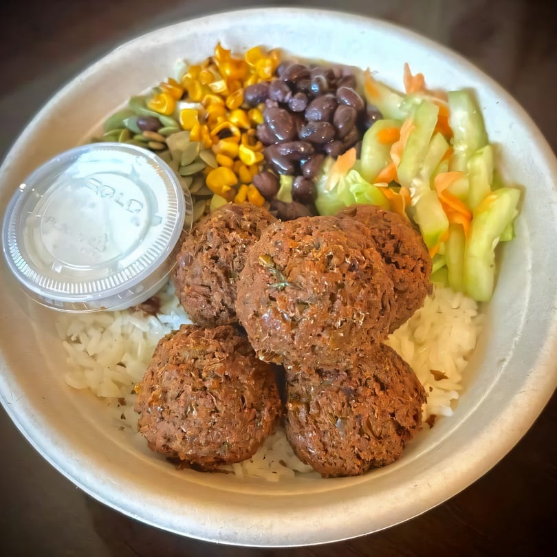 A Fusion Tikka Taco bowl with falafel, rice, corn, black beans, and pickled vegetables.